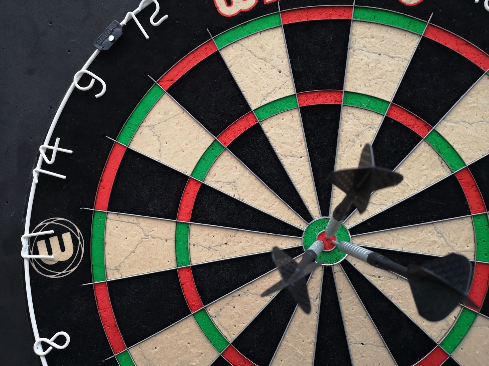 Darts in the bull of a dartboard