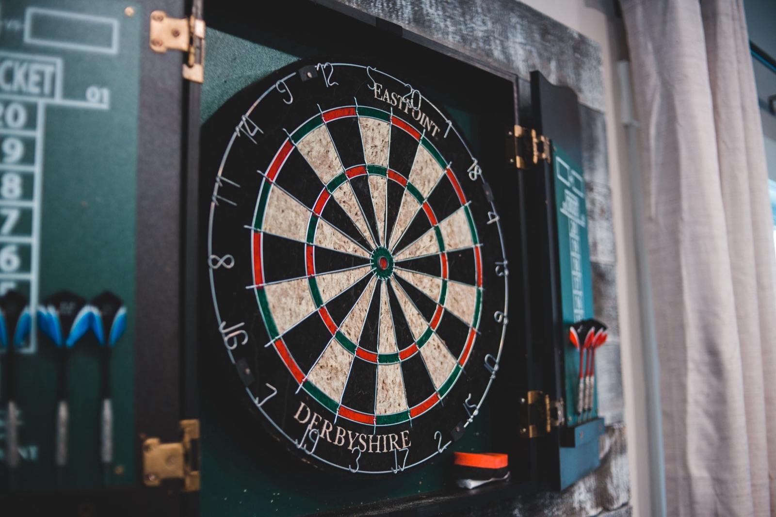 A dartboard in an open cabinet at home