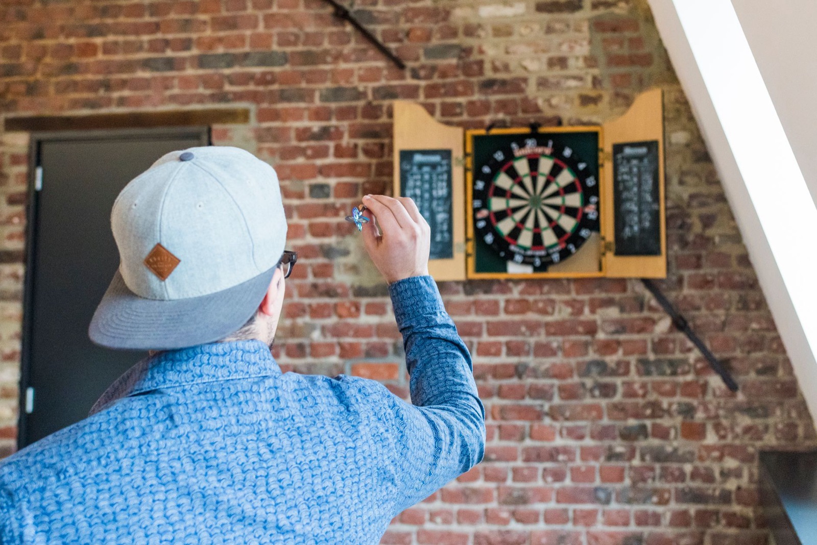 A player throwing at a board at home